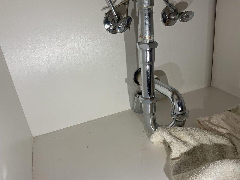 Responded to a service call for a bathroom sink experiencing slow drainage. Upon inspection, assessed the chrome-plated faucet assembly and P-trap configuration beneath the sink. Successfully cleared the obstruction from the drain line, restoring proper water flow and drainage function. Verified system operation and documented the completed work with photographs of the fixture and under-sink plumbing components.
