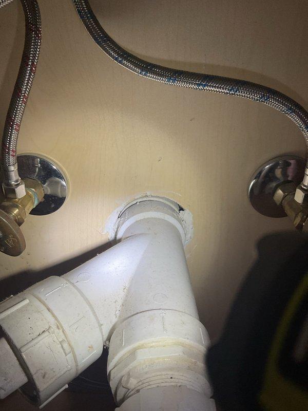 Provided estimate for installation of new garbage disposal unit under kitchen sink where no disposal previously existed. Assessed existing plumbing configuration including P-trap assembly, drain lines, and water supply connections to determine requirements for disposal installation. Photographed current under-sink conditions showing standard PVC drain piping and shut-off valves to document pre-installation setup and plan necessary modifications to accommodate new disposal unit.