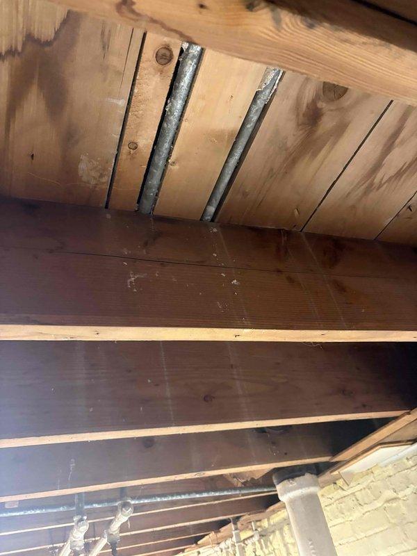 Completed plumbing stack replacement as part of ongoing remodeling project. Accessed existing cast iron or galvanized waste stack through basement/crawl space area, which showed severe deterioration with compromised exterior coating and structural integrity. Removed deteriorated section of stack and installed new PVC drainage pipe with proper support brackets secured to floor joists, ensuring code-compliant slope and connections. Documented existing conditions and completed installation with photographic evidence of before and after work.