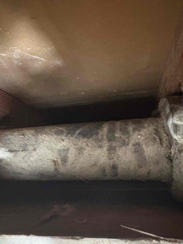 Completed plumbing stack replacement as part of ongoing remodeling project. Accessed existing cast iron or galvanized waste stack through basement/crawl space area, which showed severe deterioration with compromised exterior coating and structural integrity. Removed deteriorated section of stack and installed new PVC drainage pipe with proper support brackets secured to floor joists, ensuring code-compliant slope and connections. Documented existing conditions and completed installation with photographic evidence of before and after work.