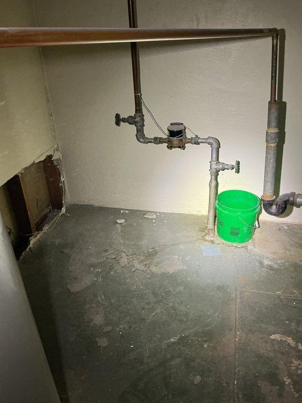 Completed comprehensive assessment of residential sewer and plumbing systems requiring multiple repairs and upgrades. Evaluated 7-foot section of compromised sewer line near main connection for repair, identified location for external cleanout installation, and assessed feasibility of trenchless sewer line lining from property to main. Inspected aging galvanized water supply piping throughout structure requiring replacement with modern materials, along with failed main water shut-off valve needing immediate replacement. Provided rough-in plumbing specifications for planned basement bathroom installation and future laundry room addition. Assessed existing water heater condition for potential replacement and identified locations for additional interior shut-off valves to improve system isolation capabilities. Documented existing plumbing infrastructure including mixed PVC and galvanized piping configurations, copper supply lines, and water meter assembly showing signs of age and previous