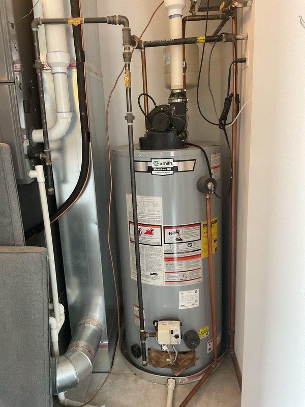 Provided estimate for replacement of 50-gallon AO Smith water heater installed in 2018 that is no longer producing hot water. Assessed existing installation including circulation pump, plumbing connections, and associated piping system in residential mechanical room to determine scope of replacement work required.