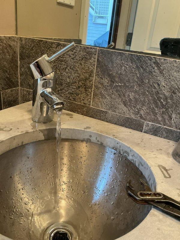 Completed dewinterization and opening of outdoor bathroom facility. Tested and verified proper operation of toilet flush valve mechanism and water supply to fixtures. Confirmed water flow to sink faucet and verified all plumbing connections were functioning correctly after seasonal reactivation.