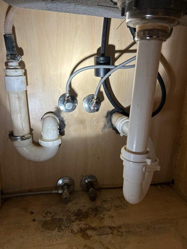 Installed customer-supplied kitchen faucet with pull-down spray head in brushed stainless steel finish. Connected braided supply lines to existing shut-off valves beneath sink and secured all plumbing connections. Verified proper operation of single-lever handle and spray function, ensuring no leaks at mounting points or supply connections.