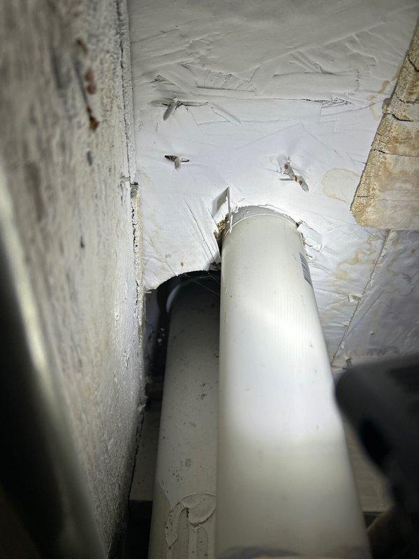 Responded to water leak complaint in first floor bathroom with reported leak originating from toilet area. Conducted thorough visual inspection of toilet fixture and surrounding plumbing infrastructure. Accessed crawl space beneath bathroom to examine water supply lines and drain connections. Located source of leak at toilet supply line connection point. Documented findings with photographs of affected plumbing components and toilet fixture for service records.