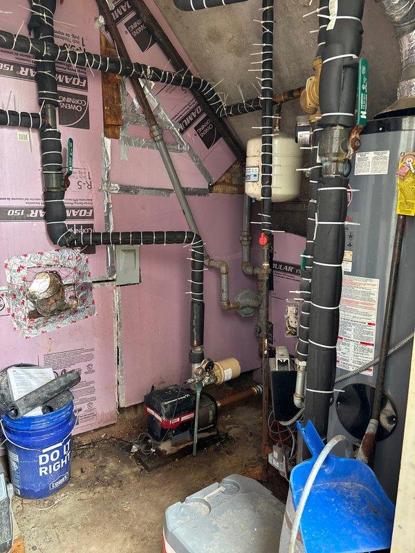 Coordinated building shutdown to complete plumbing repair work in mechanical room housing water heater and circulation system. Serviced and repaired circulator pump assembly, addressed piping connections including copper and PVC lines, and ensured proper operation of water heating system with associated mechanical components.