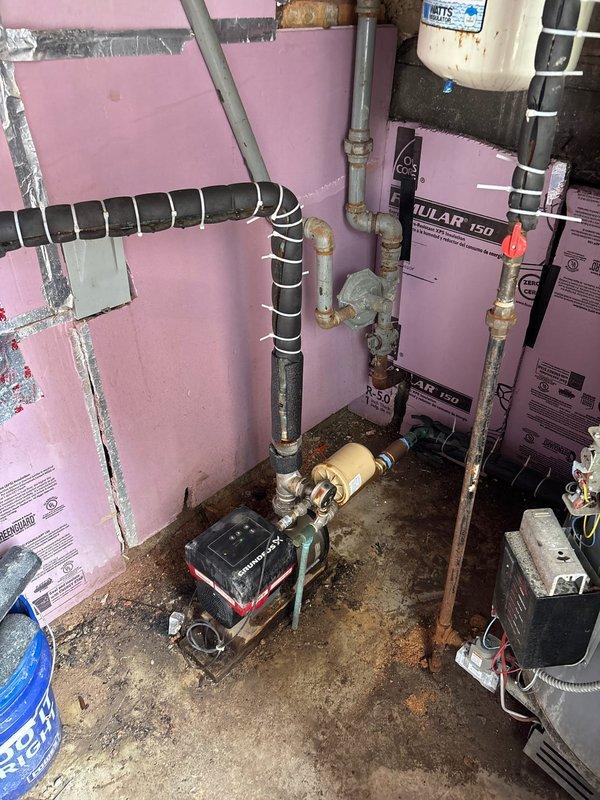 Coordinated building shutdown to complete plumbing repair work in mechanical room housing water heater and circulation system. Serviced and repaired circulator pump assembly, addressed piping connections including copper and PVC lines, and ensured proper operation of water heating system with associated mechanical components.