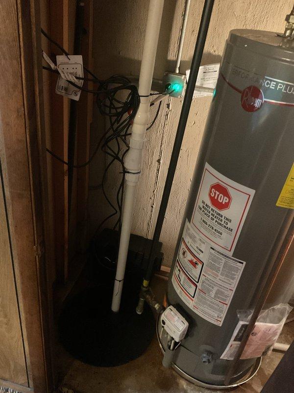Responded to water leak locate service call at residential property. Upon arrival, inspected utility area containing water heating system and associated plumbing infrastructure. Conducted thorough visual examination of Rheem Performance Plus water heater installation, including all connected piping, fittings, and valves. Inspected black metal supply lines, white PVC drainage system, and brass connection points for signs of moisture, corrosion, or active leaking. Examined teal-colored valve assembly and surrounding pipe connections for potential leak sources. Checked water heater tank exterior for condensation or water stains that might indicate internal tank failure or connection leaks. Evaluated condition of pipe joints, threaded connections, and compression fittings throughout the system. Documented equipment conditions and plumbing configuration with photographs for service records. All accessible plumbing components in mechanical room were visually assessed as part of comprehensive