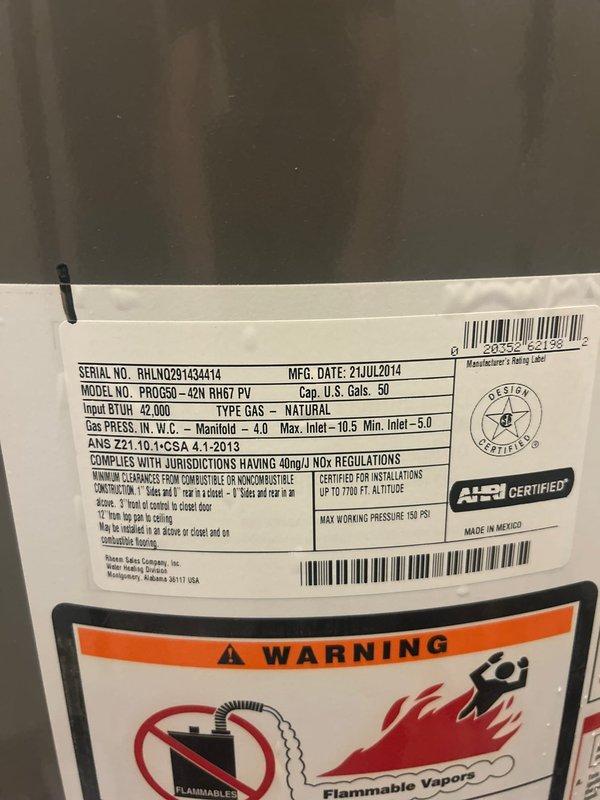 Responded to a leaking water heater emergency in a basement utility area. Upon inspection, identified active leaks originating from the top and side connections of a 10-year-old Rheem Classic 50-gallon natural gas water heater (Model PRO50G-42N RH67 PV, manufactured July 2014). Assessed all copper supply line connections, brass fittings, and top-mounted valves for failure points. Documented existing plumbing configuration including copper water lines and white PVC venting system. Photographed unit specifications, warning labels, and overall installation setup for service records and replacement recommendations.