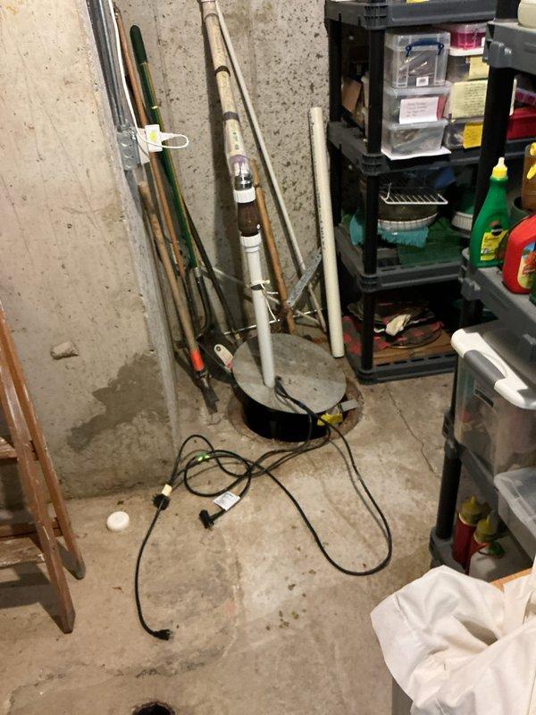 Responded to service call for sump pump running continuously with grinding noise. Upon inspection, found 15-year-old sump pump in basement utility area showing signs of mechanical failure. Pump motor exhibited grinding sounds indicative of bearing wear and impeller damage common in units of this age. Float switch mechanism was operational, but pump failed to cycle off properly due to internal component deterioration. Standing water in sump basin confirmed pump was no longer effectively evacuating water. Documented existing installation showing pump positioned in concrete basin with PVC discharge piping and electrical connections. Advised customer that pump had reached end of serviceable life and recommended replacement to prevent potential flooding risk and restore proper basement water management system functionality.