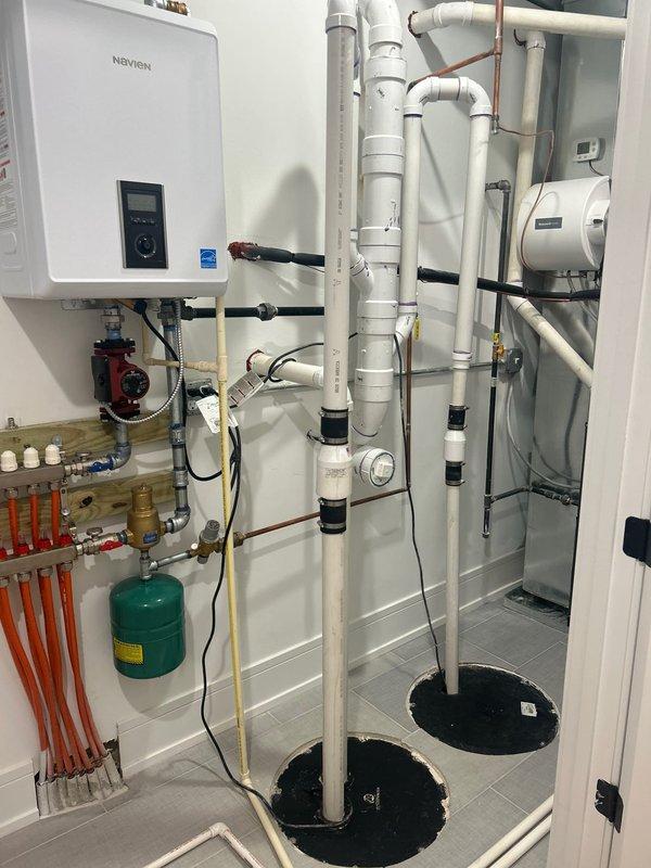 Conducted on-site evaluation of existing sump pump system consisting of two Zoeller pumps (Model M264 0.4HP and Model M63 0.3HP) to assess feasibility and requirements for battery backup installation. Inspected mechanical room containing multiple plumbing systems, including Navien tankless water heater, water heater unit, radiant heating manifold with circulation pump, expansion tanks, and extensive PVC and copper piping infrastructure. Evaluated electrical connections, pump configurations, and available space for battery backup system integration. Provided estimate for battery backup unit supply and professional installation to ensure continued sump pump operation during power outages, maintaining basement flood protection capabilities.