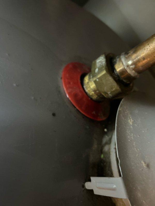 Responded to no hot water complaint and performed diagnostic evaluation of commercial water heating system. Inspected water heater connections, supply lines, and associated plumbing components including shutoff valves and copper piping. Applied plumber's putty to laundry sink drain assembly to ensure proper seal and prevent leaking.
