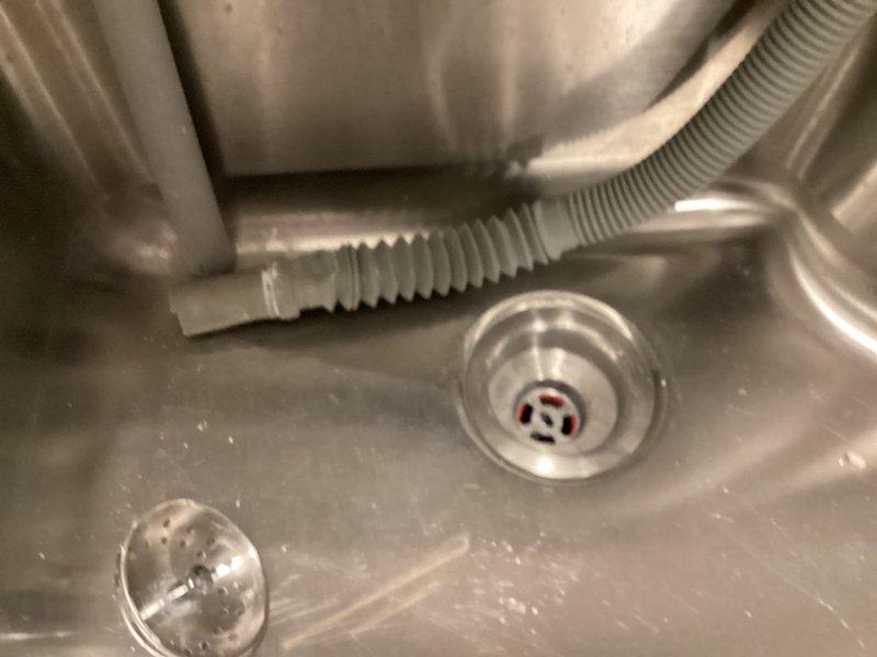 Responded to no hot water complaint and performed diagnostic evaluation of commercial water heating system. Inspected water heater connections, supply lines, and associated plumbing components including shutoff valves and copper piping. Applied plumber's putty to laundry sink drain assembly to ensure proper seal and prevent leaking.