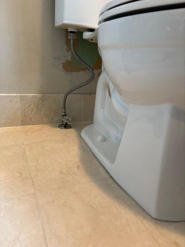 Completed toilet installation using customer-supplied fixture at afternoon appointment. Removed existing toilet, verified proper floor flange condition and measurements, and installed new white porcelain toilet with appropriate wax ring seal. Connected water supply line from wall-mounted shutoff valve to tank fill valve using flexible supply hose, ensuring proper alignment and leak-free connections. Verified toilet was level, properly secured to floor flange, and tested flush operation and tank refill function to confirm successful installation.