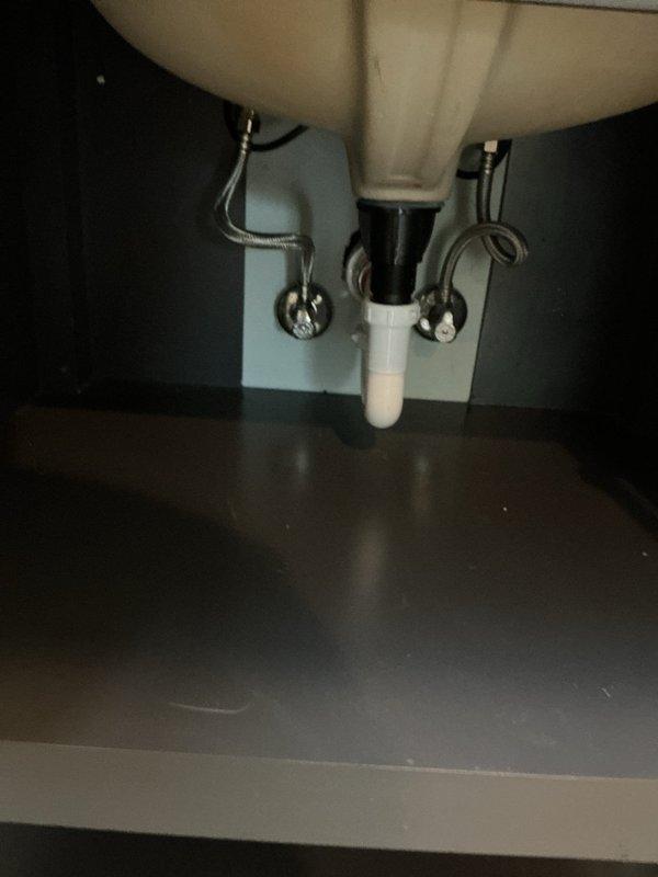 Replaced bathroom faucet with customer-supplied brushed nickel widespread three-piece faucet set on marble vanity countertop. Removed existing fixture, installed new widespread faucet assembly with central spout and dual handle controls, connected braided stainless steel supply lines to existing shut-off valves, and verified proper water flow and drainage with no leaks detected.