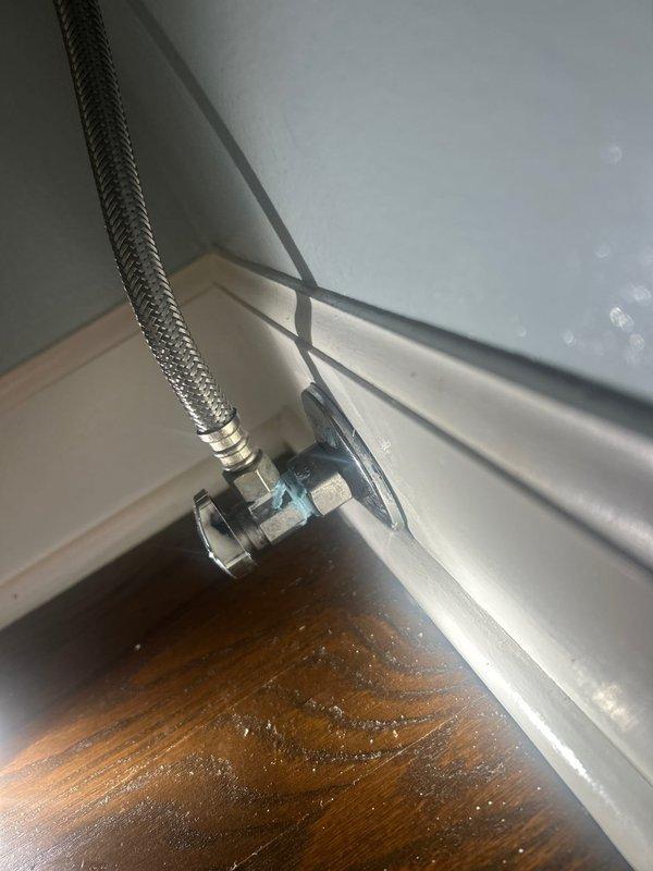 Responded to a leaking toilet on the main floor. Upon inspection, identified a faulty water supply connection at the angle stop valve. Replaced the braided stainless steel flexible supply line and secured all connections to the shutoff valve and toilet tank inlet. Tested the system for proper operation and verified no leaks were present at the valve connection points or supply line fittings.