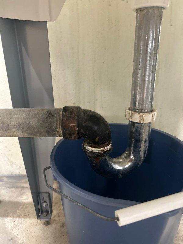 Responded to service call for disconnected utility sink P-trap requiring repair or replacement. Upon inspection, found the white PVC P-trap assembly had separated from the drainage system, causing potential water leakage issues. Successfully reconnected and secured the P-trap assembly to the vertical drain pipe, ensuring proper alignment and watertight seal at all connection points. Verified trap configuration maintains proper water seal to prevent sewer gas infiltration. Tested drainage system for leaks and confirmed proper flow through the reassembled P-trap and connecting pipes. System restored to full operational status with no active leaks detected.