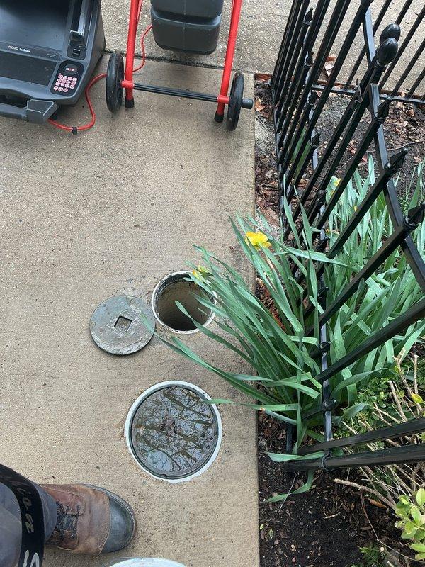 Responded to emergency basement flooding situation and successfully installed flood control system to protect property from water intrusion. System includes drainage access points with grated covers embedded in concrete surface to facilitate proper water management and prevent future flooding incidents.