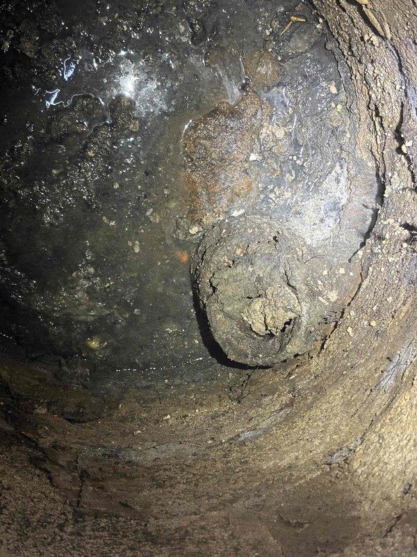 Responded to service call for water backup and sewer concerns. Upon inspection, found catch basin completely filled with accumulated debris, sediment, and organic material causing drainage obstruction. Basin interior showed significant buildup on walls and bottom, with heavy deposits restricting flow capacity. Performed complete catch basin cleaning, removing all debris and sediment to restore proper drainage function and prevent further backup issues.