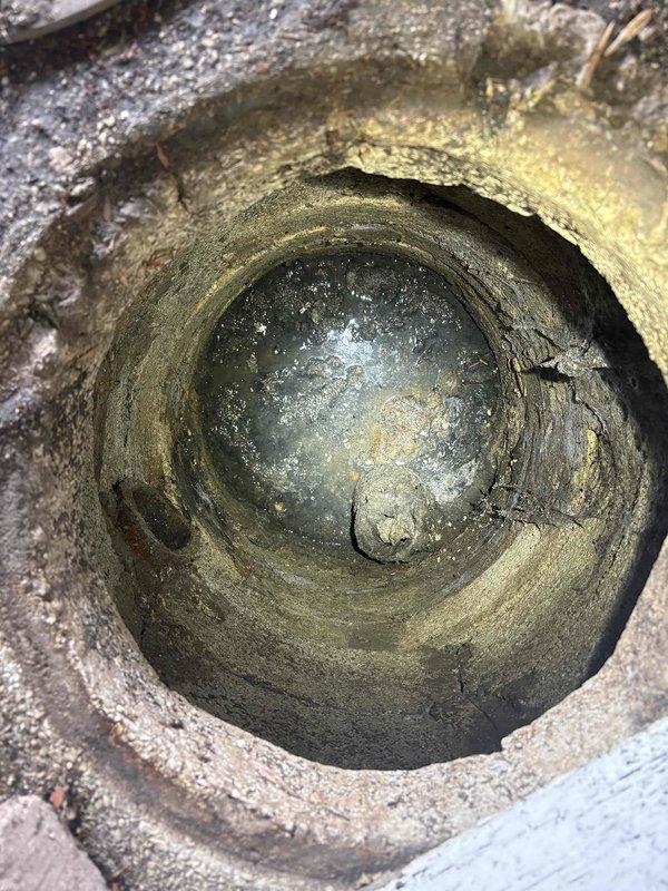 Responded to service call for water backup and sewer concerns. Upon inspection, found catch basin completely filled with accumulated debris, sediment, and organic material causing drainage obstruction. Basin interior showed significant buildup on walls and bottom, with heavy deposits restricting flow capacity. Performed complete catch basin cleaning, removing all debris and sediment to restore proper drainage function and prevent further backup issues.