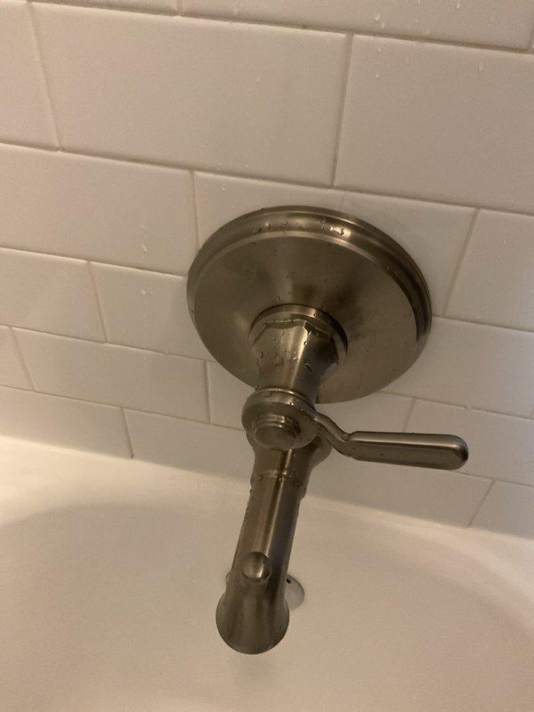 Responded to low hot water pressure complaint affecting single shower in second-floor unit of century-old residential property. Inspected bathroom fixtures including tub/shower valve assembly with brushed nickel finish and standard lever-style control mechanism mounted on subway tile surround. Assessed water flow from tub spout and shower diverter, examined valve cartridge operation, and checked for potential sediment buildup or mineral deposits restricting hot water delivery. Documented existing fixture condition showing normal wear consistent with age and mineral exposure. Investigated potential causes including partially closed shutoff valves, corroded galvanized supply piping common in older properties, faulty mixing valve cartridge, or sediment accumulation in hot water lines from basement-located water heaters serving the building.