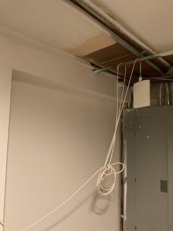 Responded to report of outdoor spigot leaking when operated from both exterior and interior shut-off locations. Accessed interior wall cavity to locate and diagnose the source of the leak in the supply line feeding the exterior hose bib. Created access opening in basement utility area wall to expose copper piping and valve assembly for inspection and repair.