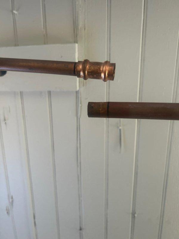 Responded to warranty service call for leaking outdoor spigot and bathroom faucet. Inspected disconnected exterior hose bib and assessed copper supply line connections behind interior wall access point. Identified leak source at coupling joint on copper piping. Provided estimate for bathroom faucet replacement as requested.