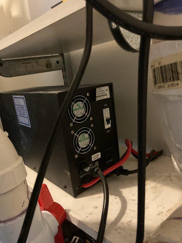 Responded to service call for battery pricing inquiry on sump pump backup system. Inspected and photographed Ion Genesis Take Control dual pump control unit showing P1 excess runtime alarm and illuminated alarm indicator, suggesting primary pump operational issues. Documented backup battery power supply unit with dual cooling fans in operational condition. System requires battery replacement to maintain emergency backup functionality during power outages.