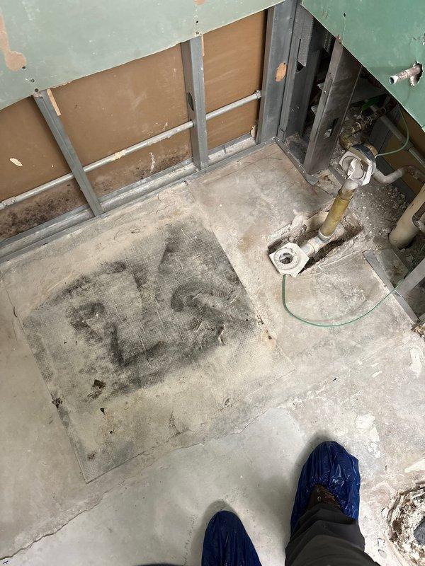 Installed shower pan in commercial building during scheduled facility shutdown. Completed rough plumbing connections to existing drain line and secured flange assembly to concrete floor in preparation for final shower installation. Building water systems were temporarily shut down to facilitate safe installation of the new shower pan assembly.