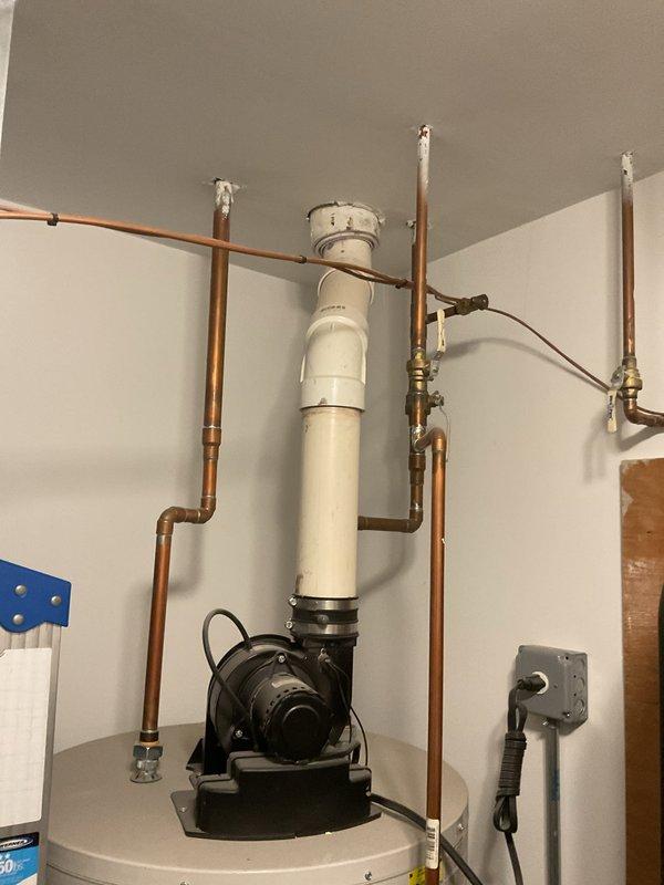 Responded to service call for water heater leaking from pipe at bottom of tank. Upon inspection, identified leak originating from threaded connection at base of unit. Assessed entire plumbing assembly including copper supply lines, brass fittings, dielectric unions, and circulation pump mounted atop water heater. Tightened leaking connection and verified integrity of all pipe joints, valves, and fittings throughout the system. Inspected PVC venting, circulation pump operation, and Honeywell control unit for proper functionality. Tested system under pressure to confirm leak was resolved and all connections remained secure with no further water discharge detected.