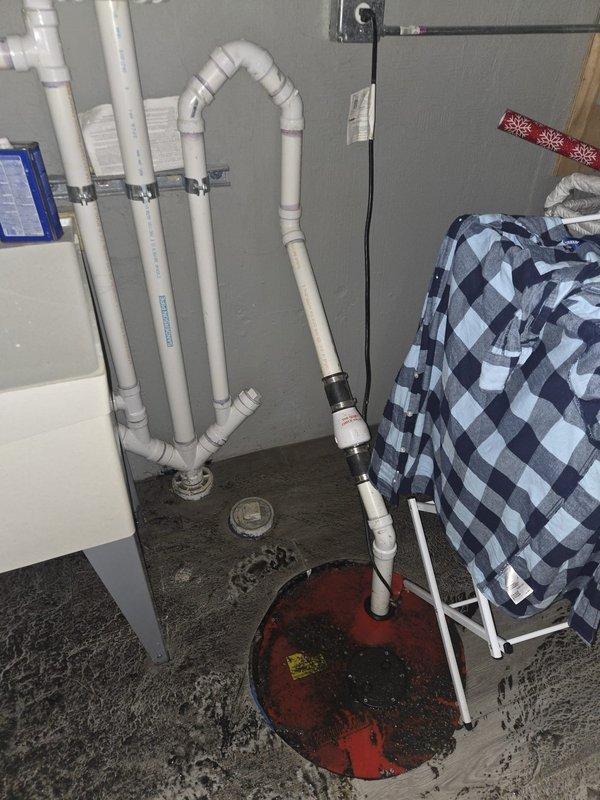 Responded to emergency basement flooding caused by failed sump pump. Upon arrival, found standing water in utility room with inoperative pump system. Removed failed pump unit from sump basin, which showed significant sediment accumulation and debris buildup. Cleaned sump pit interior, removing dirt and standing water. Installed new replacement sump pump with proper float switch configuration and electrical connections. Tested system operation to ensure proper activation and discharge through existing PVC drainage piping. Verified all connections were secure and system cycled correctly. Basement water level returned to normal with pump functioning as designed.