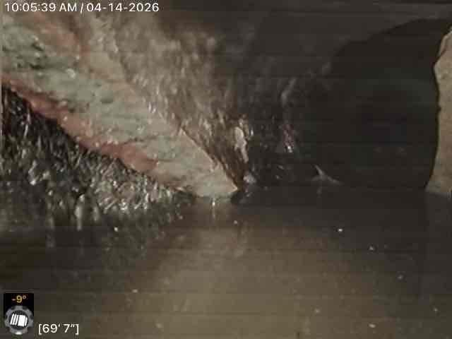 Conducted commercial drain and sewer system assessment requiring management consultation prior to finalizing scope of work. Documented existing conditions of plumbing fixtures and infrastructure, including bathtub drainage components with visible overflow and floor drain assemblies showing signs of age and mineral deposits. Inspected crawl space and foundation areas to evaluate subsurface drainage conditions, identifying foundation walls with moisture exposure and potential drainage concerns requiring further evaluation before proceeding with estimate recommendations.
