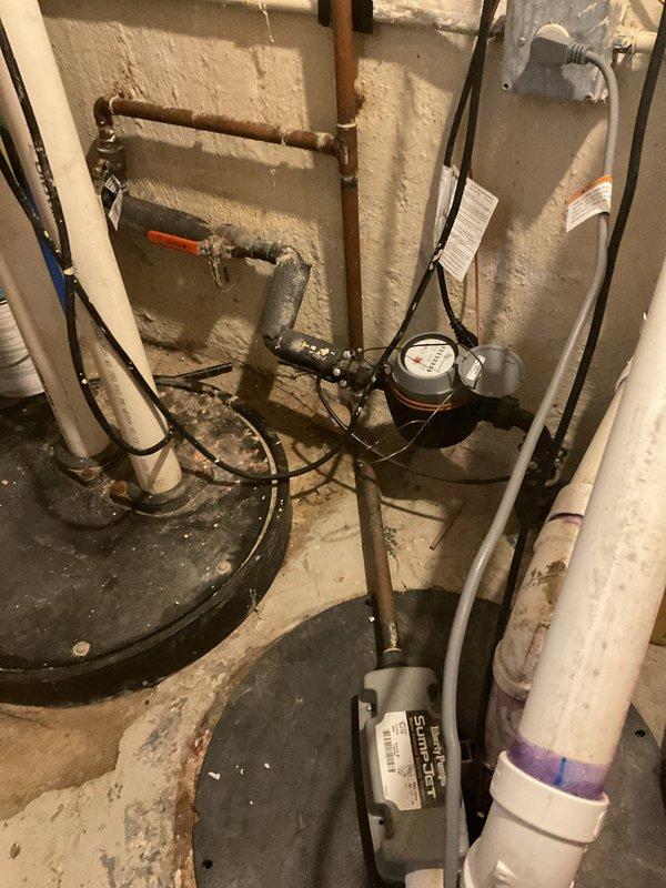 Responded to morning appointment for sump pump evaluation in basement utility area. Upon inspection, assessed existing sump pump system including basin, discharge piping, and electrical connections in unfinished basement space with exposed mechanical systems. Documented current installation configuration with white PVC discharge pipe and power supply setup. Provided comprehensive estimate for VIP sump pump replacement including removal of existing unit, installation of new pump system, and proper integration with existing plumbing infrastructure and electrical components.