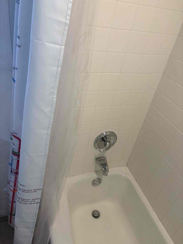 Completed on-site assessment for basement bathroom plumbing remodel. Evaluated existing bathroom configuration including bathtub with chrome fixtures, shower assembly, and tiled surround to determine scope of work for renovation. Inspected water heater installation, copper supply lines, shutoff valves, and electrical connections in utility area to assess current plumbing infrastructure and compatibility with proposed bathroom modifications. Documented existing conditions through photography and provided comprehensive estimate for complete bathroom plumbing remodel.