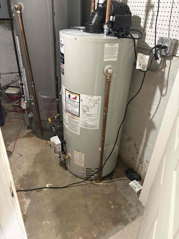 Completed on-site assessment for basement bathroom plumbing remodel. Evaluated existing bathroom configuration including bathtub with chrome fixtures, shower assembly, and tiled surround to determine scope of work for renovation. Inspected water heater installation, copper supply lines, shutoff valves, and electrical connections in utility area to assess current plumbing infrastructure and compatibility with proposed bathroom modifications. Documented existing conditions through photography and provided comprehensive estimate for complete bathroom plumbing remodel.
