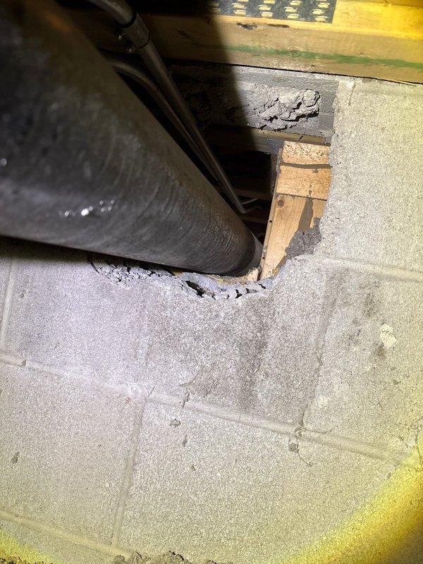 Completed plumbing repair work in crawl space area involving deteriorated copper piping showing significant corrosion and mineral deposits. Protected work areas in unit 2 pantry and storage unit with plastic sheeting as planned. Addressed compromised concrete flooring near mechanical systems where cracking and structural deterioration were evident, with exposed underlayment and damaged foundation edges requiring attention during the repair process.