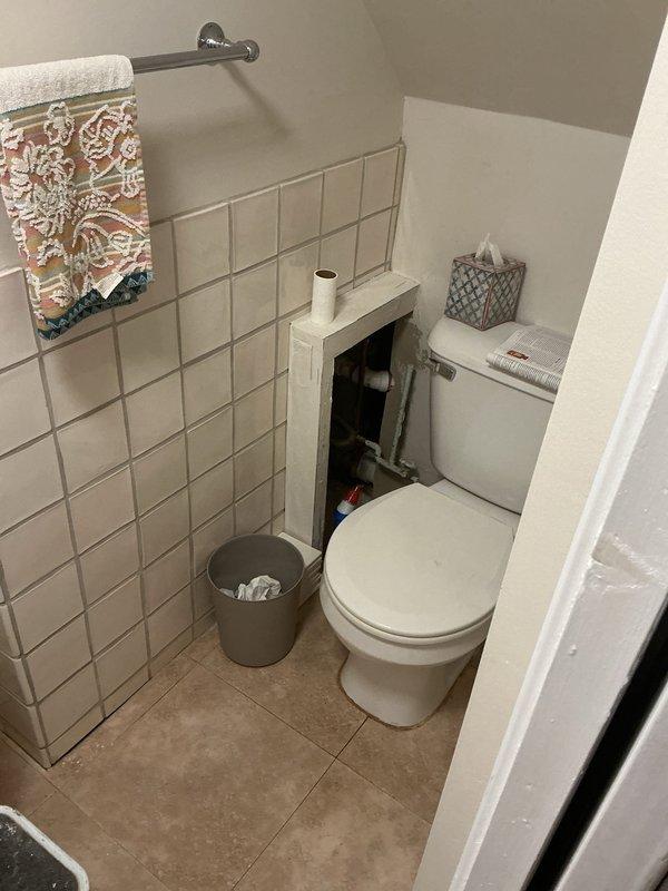 Performed comprehensive camera inspection of main sewer line and ejector pit system to assess disconnection issues in basement area. Inspection revealed need for excavation work to properly reconnect main sewer line to ejector pit, with documentation provided through photographic evidence of affected utility areas including basement storage space and adjacent bathroom facilities.