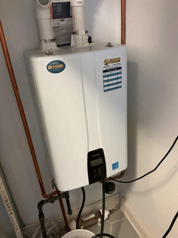 Completed annual preventive maintenance service on wall-mounted tankless water heater unit. Performed comprehensive inspection of all plumbing connections, copper piping, shutoff valves, and inlet/outlet fittings to verify proper operation and identify potential issues. Examined unit's digital control panel, tested temperature settings, and confirmed proper functionality of all safety features and Energy Star rated components. Inspected PVC venting system, electrical connections, and mounting hardware for secure installation. Flushed system to remove mineral buildup and sediment accumulation, ensuring optimal heat exchanger performance and efficiency. Verified adequate water flow rates and pressure at all connection points. Checked all visible pipe joints, compression fittings, and isolation valves for signs of leaks or corrosion. Documented unit condition with photographic records showing installation in utility room alongside HVAC equipment. All systems operating within manufacturer 