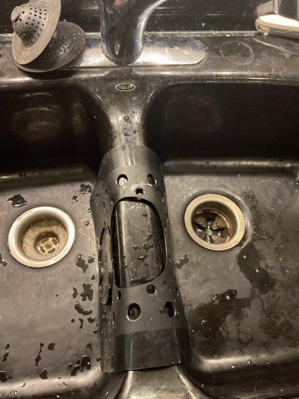 Responded to service call for garbage disposal backup affecting multiple units. Upon inspection, found disposal unit draining improperly, causing wastewater to back up into neighboring sink. Assessed under-sink plumbing configuration including P-trap assembly and drainage connections. Cleared blockage from disposal unit and verified proper drainage flow through shared waste line. Tested system operation to ensure complete resolution with no cross-contamination between units.