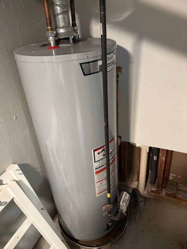 Conducted comprehensive inspection of residential water heater following customer reports of operational issues. Evaluated unit condition, plumbing connections, and overall system integrity. Documented existing installation showing age-related wear including corroded copper piping, oxidized fittings, and evidence of previous moisture accumulation in drain pan. Coordinated scheduling for flood control pump installation and acid neutralizer system work as requested by homeowner.