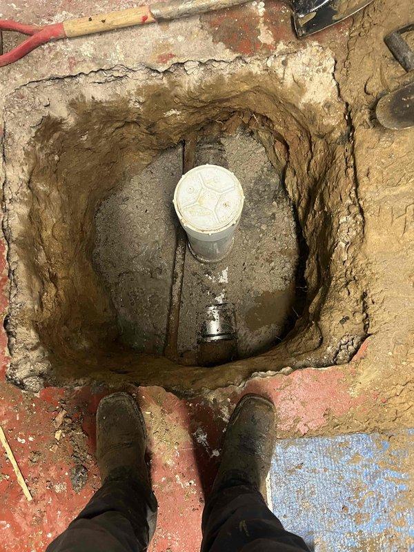 Excavated and exposed deteriorated brick-lined drain shaft for inspection and repair assessment. The existing masonry structure showed significant age-related deterioration with crumbling mortar joints, moisture damage, and efflorescence buildup on interior brick surfaces. Excavation revealed standing water at the base of the shaft and compromised structural integrity of the brick lining. Documented current conditions through photographic evidence for repair scope development and customer approval of necessary restoration work.