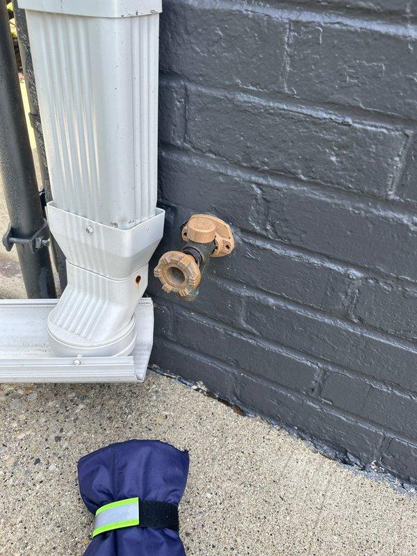Responded to report of leaking outdoor spigot with water supply shut off. Upon arrival, inspected exterior hose bib mounted on painted brick wall and identified source of leak. Replaced faulty spigot assembly with new frost-proof hose bib, ensuring proper seating against masonry and secure mounting. Restored water supply and tested fixture under full pressure to verify leak was eliminated and proper operation of shutoff valve. No additional leaks detected at connection points or through wall penetration.