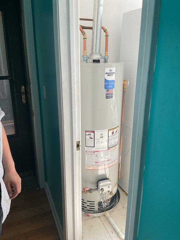 Completed morning appointment for water heater inspection and repair sale. Evaluated Bradford White automatic storage water heater model W22470T6 installed in closet space with standard copper supply line connections and PVC venting. Documented unit condition with all manufacturer labels, safety warnings, and specification plates intact and legible. All plumbing connections, drain pan, and venting configuration photographed and confirmed to be in proper working order for customer records and future service reference.