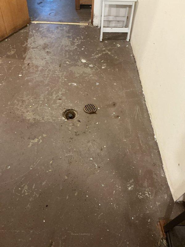 Responded to service call for catch basin drainage issues causing interior flooding during heavy rainfall events. Inspected outdoor catch basin and found standing sewer water indicating drainage obstruction. Documented interior water damage where groundwater had previously infiltrated through floor cracks during periods of excessive precipitation, requiring temporary pump usage by property owner to prevent backups into living space.