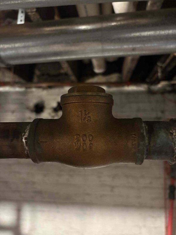 Responded to commercial building experiencing hot water issues with recently installed tank water heater system. Performed comprehensive inspection of stainless steel commercial water heater unit, all associated plumbing connections, circulation pump, and venting components to provide second opinion on previously recommended cartridge replacements. Evaluated system performance, examined copper piping, circulator pump operation, T-fitting check valves, and all mechanical connections to identify root cause of inadequate hot water supply throughout the building.