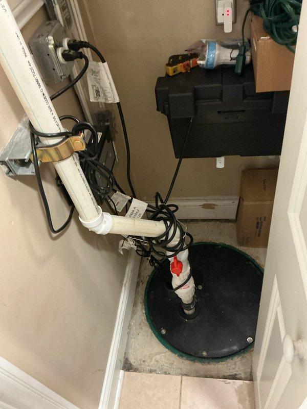 Completed VIP plumbing maintenance inspection of residential property. Performed comprehensive camera inspection of sump pump system in utility room, documenting proper installation and operation of pump assembly with PVC discharge piping, check valve, and electrical connections. Verified bathroom plumbing fixtures including shower system and vanity lighting for proper function and identified no immediate concerns requiring repair.