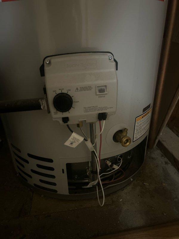 Responded to service call for residential water heater with no hot water production throughout home. Upon arrival, inspected 70-year-old home's utility closet containing tanked gas water heater unit. Performed diagnostic assessment of water heater system, examining gas control valve assembly, thermocouple connections, and pilot light operation. Checked gas supply line, brass fittings, and all copper piping connections for proper function. Evaluated temperature and pressure relief valve, inspected flue venting system, and verified proper combustion air supply. Tested electrical connections including thermocouple wiring and safety controls. Assessed overall unit condition including tank integrity, insulation, and manufacturer specifications label. Documented equipment configuration with utility room layout showing water heater positioned adjacent to HVAC furnace system with metal ductwork overhead. Restored hot water service to residence and verified proper operation of heating elements 