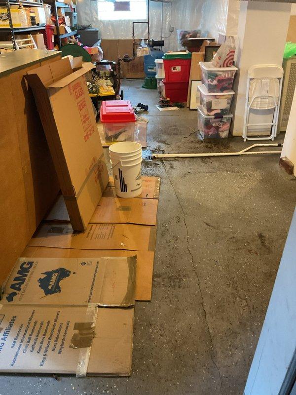 Responded to customer report of water backing up through basement floor drains. Upon arrival, conducted thorough inspection of the drain line system and identified signs of previous water accumulation around the basement floor drain, evidenced by dark staining on the concrete floor surrounding the drain opening. Assessed the drainage system to determine the cause of the backup and evaluated the extent of the issue affecting the basement area. Documented conditions with photographic evidence showing water damage patterns and drain location for further evaluation and recommended course of action.