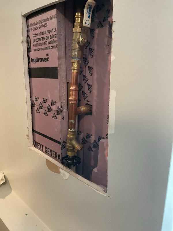 Responded to warranty callback for leaking water connection related to previous outdoor spigot replacement. Accessed interior wall cavity to inspect plumbing assembly and identified improper press fitting on copper piping that was causing the leak. Corrected the faulty connection by properly executing the press fitting technique on the brass valve assembly, ensuring secure watertight seal. Verified all shut-off valves and pressure relief components were functioning correctly and tested system for leaks under full pressure. Restored wall access panel and confirmed complete resolution of the water leak issue.