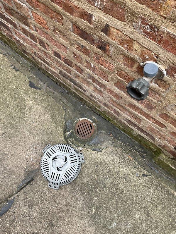 Completed preventative maintenance sewer line cleaning and inspection for two residential properties, clearing main lines from house to street connection. Accessed exterior cleanout points showing significant moisture damage and biological growth around foundation drainage areas. Removed drain grates to perform thorough rodding and hydro-jetting of main sewer laterals, ensuring proper flow and identifying deteriorated conditions at building perimeter requiring future attention.